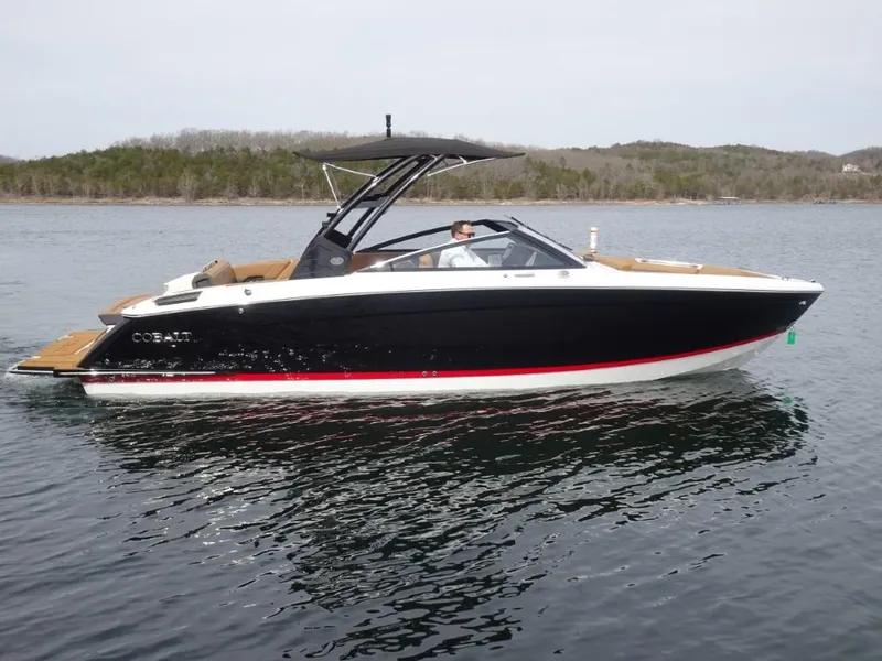 Slide: The Image of 2025 Cobalt R8 boat on a calm lake with scenic background. - 2