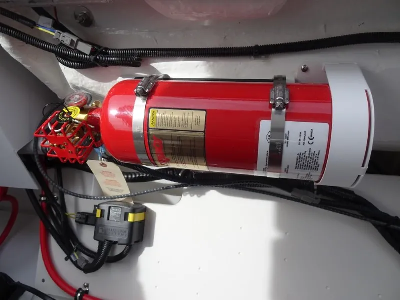 Slide: The Image of Red fire extinguisher mounted in a 2025 Cobalt R8 engine compartment. - 22