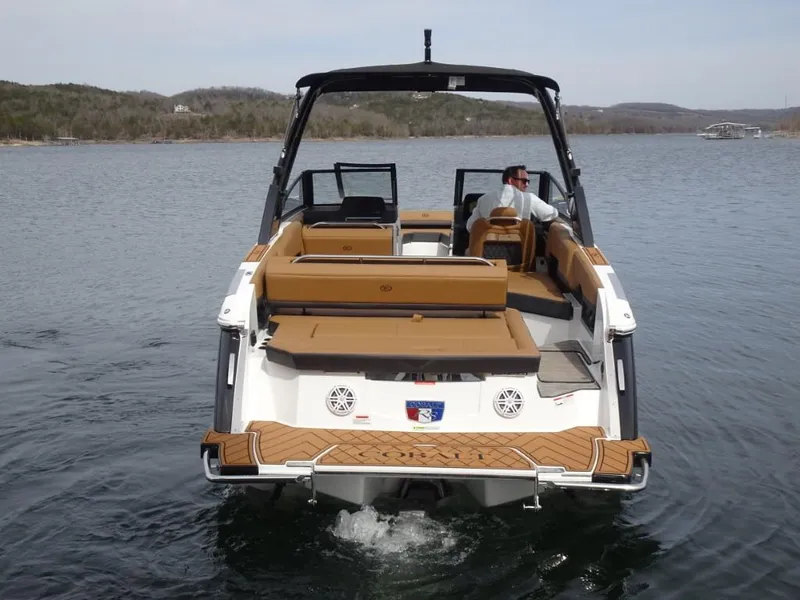 Slide: The Image of 2025 Cobalt R8 boat cruising on a lake with scenic background. - 4