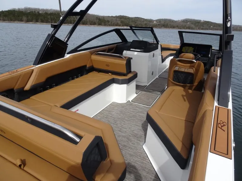 Slide: The Image of 2025 Cobalt R8 boat interior with tan seating, sleek design, and open water view. - 8