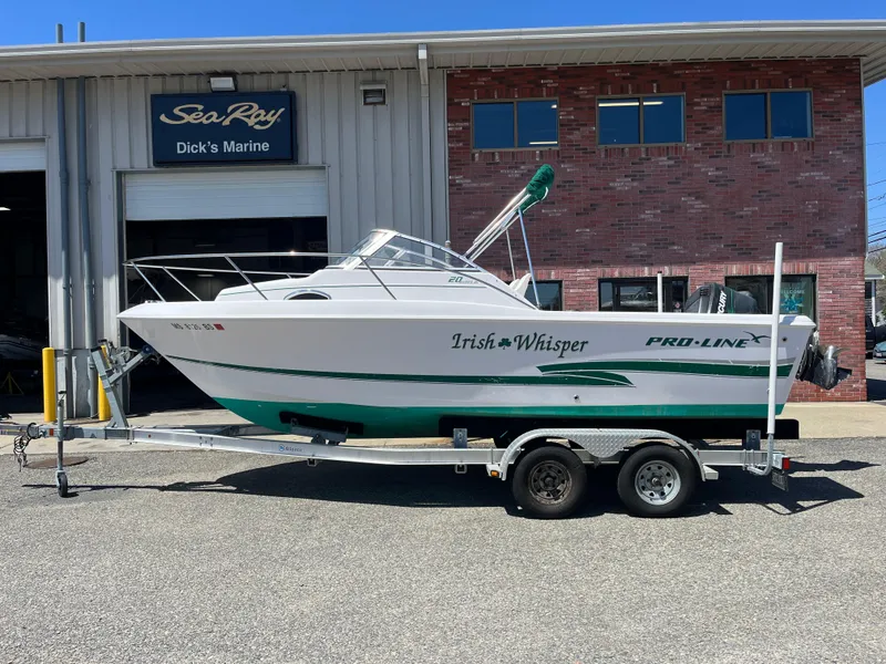 Slide: The Image of 2001 Pro-Line 20 WALK boat on trailer outside Dick's Marine. - 1