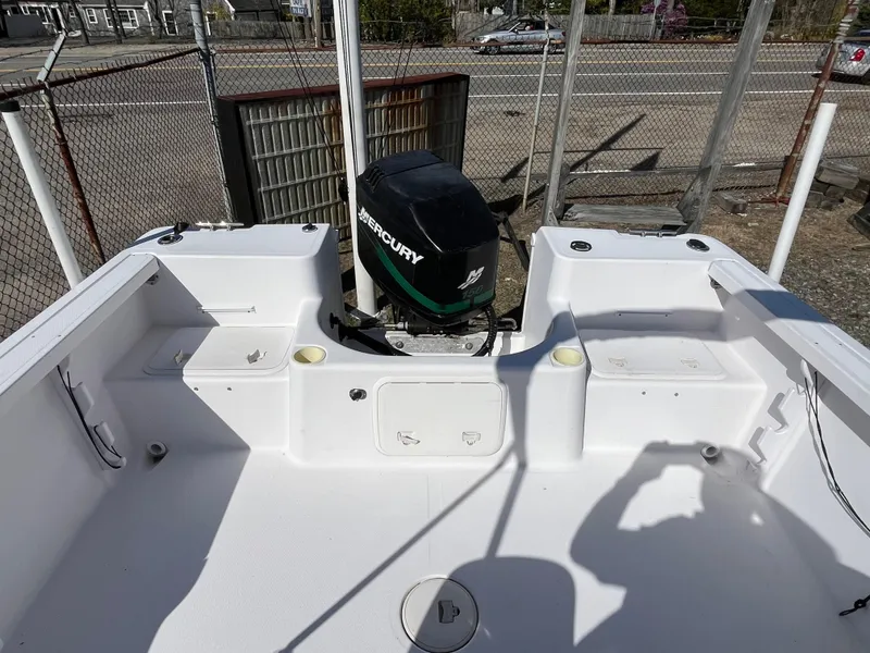 Slide: The Image of 2001 Pro-Line 20 WALK boat with Mercury outboard motor, docked in a fenced area. - 11