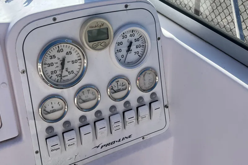 Slide: The Image of Dashboard of a 2001 Pro-Line 20 WALK boat with gauges and switches. - 12