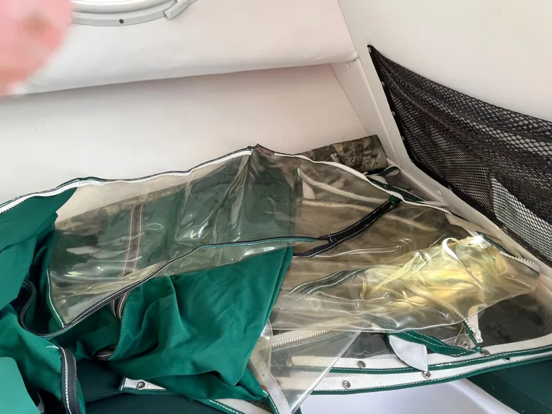 Slide: The Image of Green and clear boat cover inside a 2001 Pro-Line 20 WALK cabin. - 14