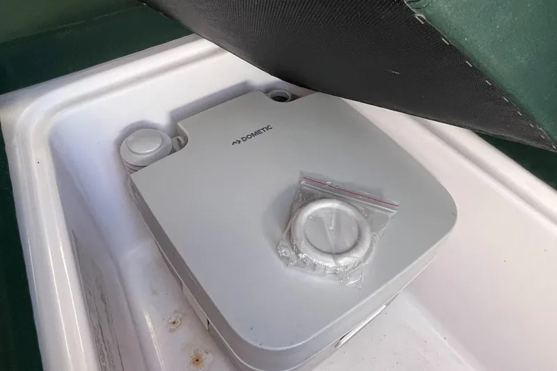 Slide: The Image of Portable Dometic toilet in a 2001 Pro-Line 20 WALK boat compartment. - 15