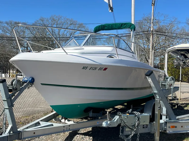 Slide: The Image of 2001 Pro-Line 20 WALK boat on trailer, white with green accents, parked outdoors. - 3