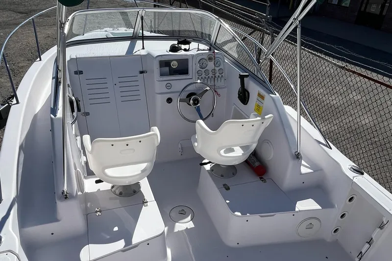 Slide: The Image of 2001 Pro-Line 20 WALK boat interior with dual seats and control panel. - 7