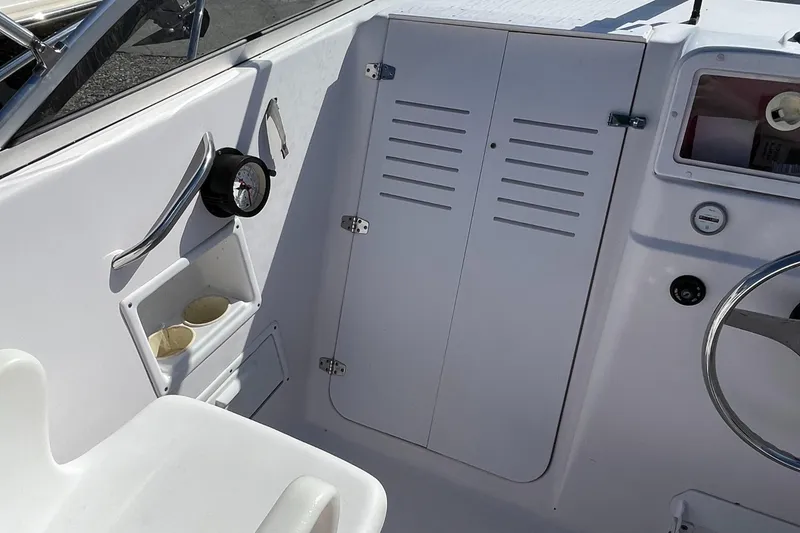Slide: The Image of 2001 Pro-Line 20 WALK boat interior with steering wheel and storage compartments. - 9