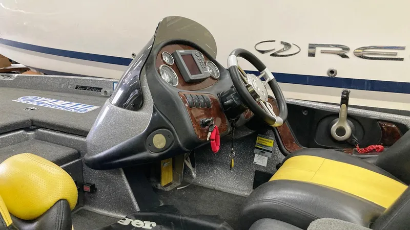 Slide: The Image of 2007 Ranger 519 VX boat interior with yellow and black seats, steering wheel, and dashboard. - 4