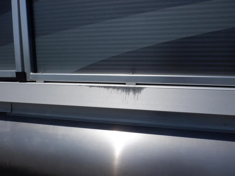 Slide: The Image of 2014 Weeres Cadet Cruise 200 pontoon with visible surface damage. - 10