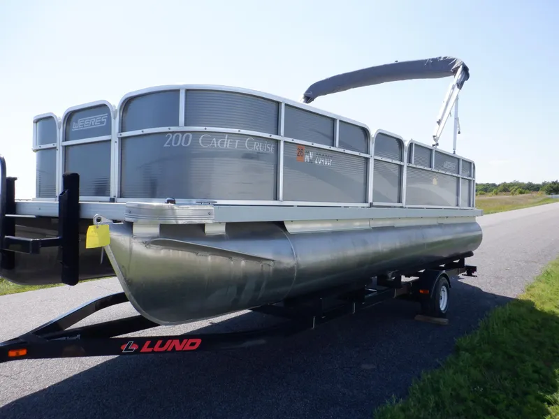 Slide: The Image of 2014 Weeres Cadet Cruise 200 pontoon boat on a trailer, parked on a road. - 11