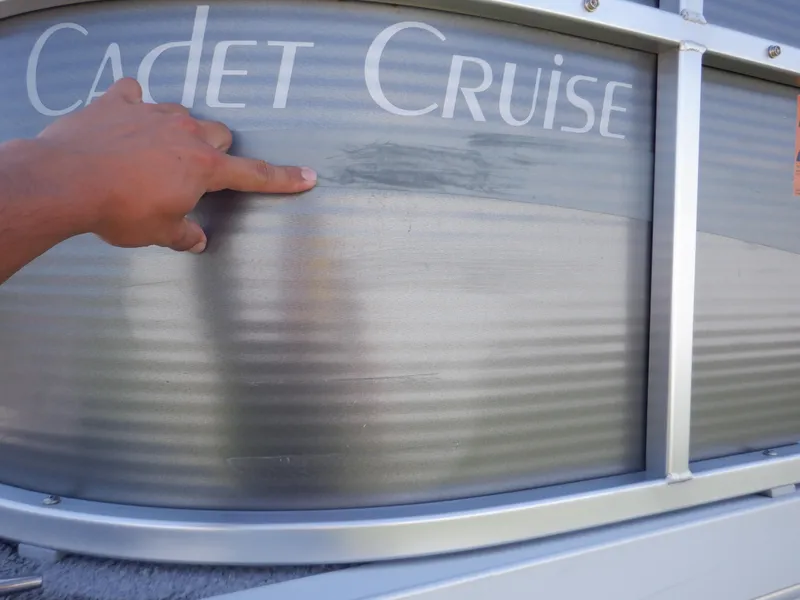 Slide: The Image of 2014 Weeres Cadet Cruise 200 pontoon boat with hand pointing at the side panel. - 12