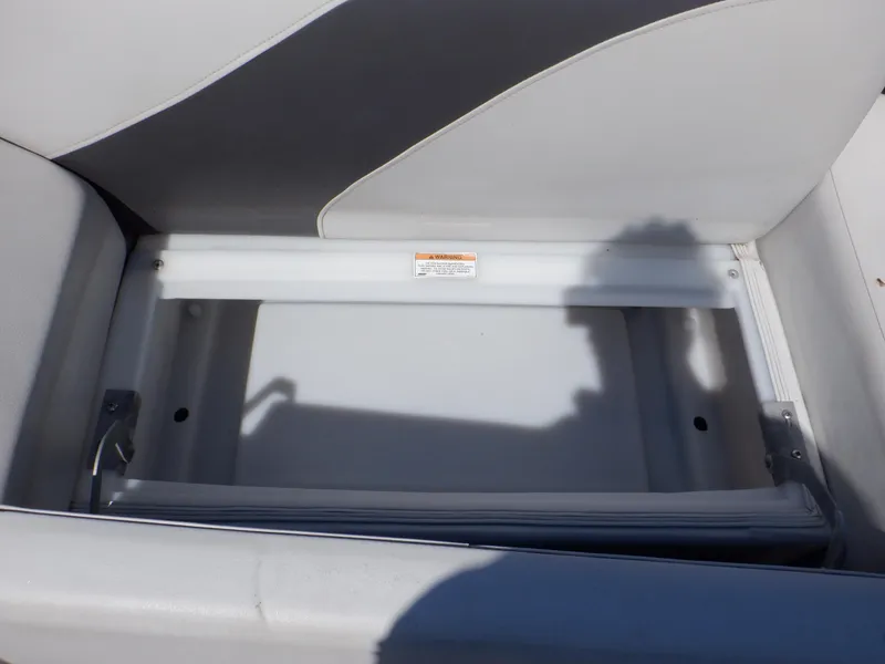Slide: The Image of Open storage compartment on 2014 Weeres Cadet Cruise 200 boat seat. - 19