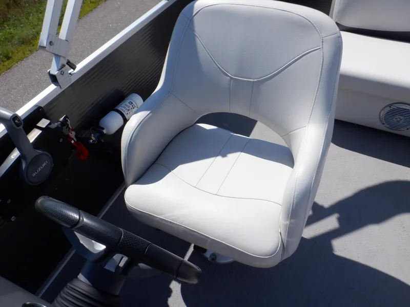 Slide: The Image of 2014 Weeres Cadet Cruise 200 boat seat and steering wheel, featuring a white cushioned chair. - 23