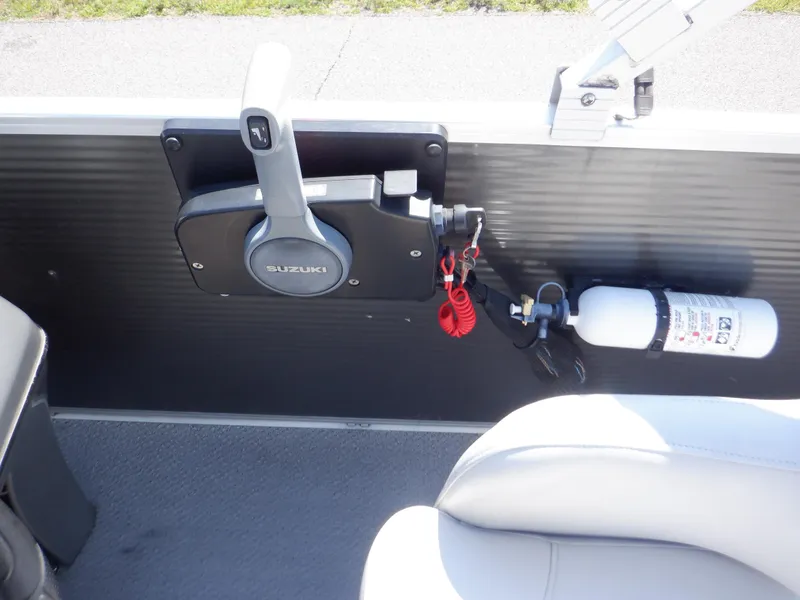Slide: The Image of 2014 Weeres Cadet Cruise 200 boat control panel with Suzuki throttle and fire extinguisher. - 24