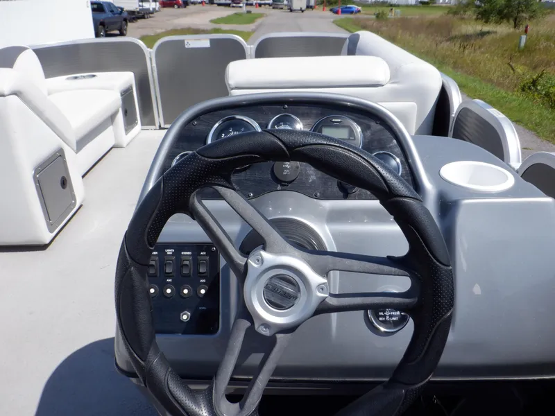 Slide: The Image of 2014 Weeres Cadet Cruise 200 boat dashboard with steering wheel and control panel. - 27