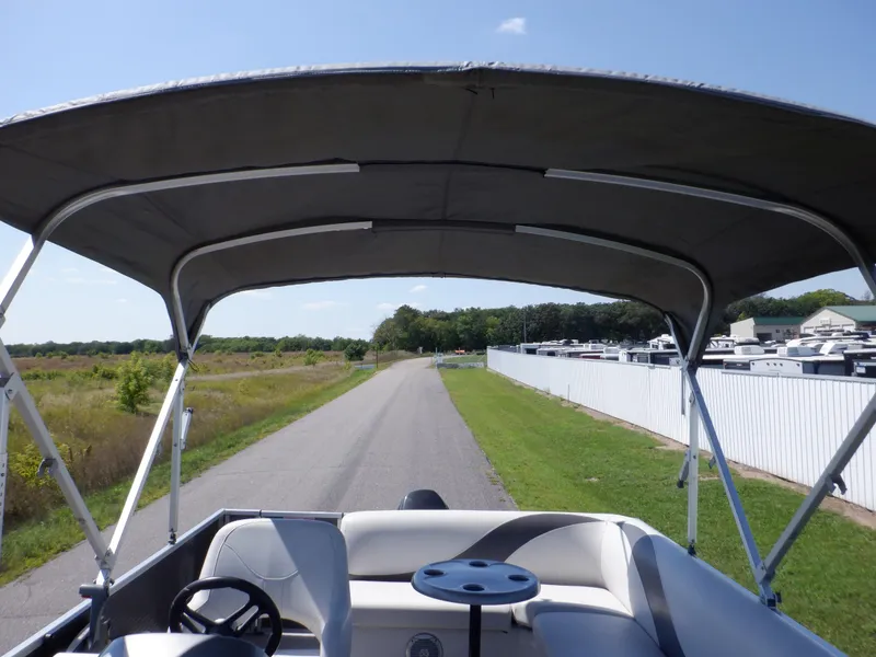 Slide: The Image of 2014 Weeres Cadet Cruise 200 pontoon boat with canopy on a sunny day. - 33