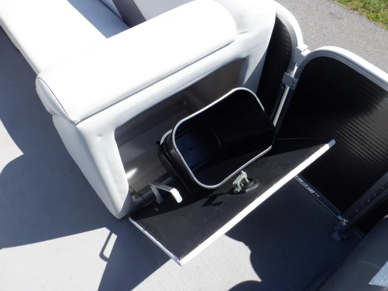 Slide: The Image of 2014 Weeres Cadet Cruise 200 boat storage compartment with open hatch and bin. - 34
