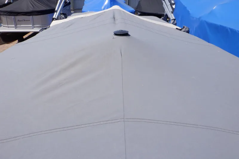 Slide: The Image of 2014 Weeres Cadet Cruise 200 boat with protective cover, docked alongside other boats. - 36