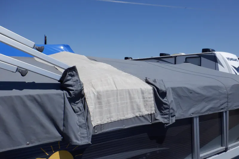 Slide: The Image of 2014 Weeres Cadet Cruise 200 boat with gray cover under clear blue sky. - 37