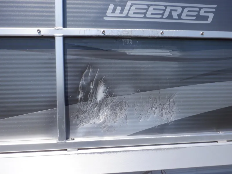 Slide: The Image of 2014 Weeres Cadet Cruise 200 with visible exterior damage. - 9