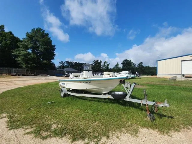 Slide: The Image of 2007 Sundance SV17 boat on trailer in grassy area under blue sky. - 2