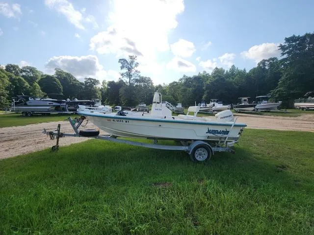 Slide: The Image of 2007 Sundance SV17 boat on trailer in grassy area, surrounded by trees and other boats. - 3