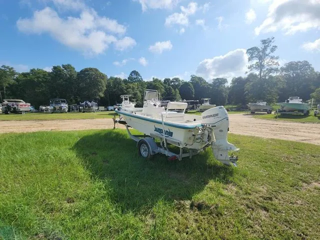 Slide: The Image of 2007 Sundance SV17 boat on trailer in grassy outdoor area, surrounded by trees and other boats. - 5