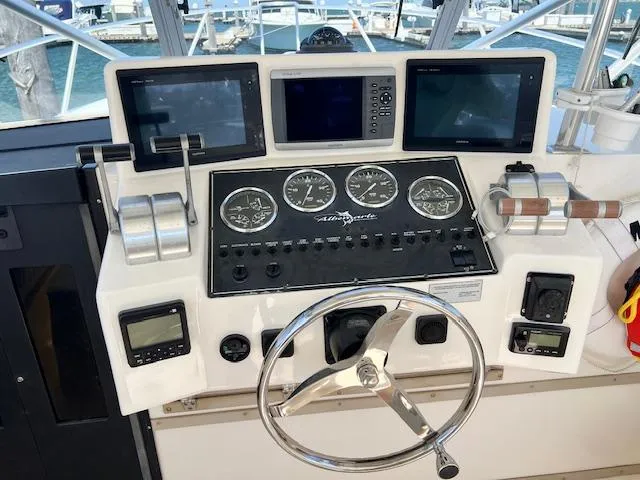 Slide: The Image of Control panel of a 1999 Albemarle 305 Express Fisherman boat with navigation instruments. - 11