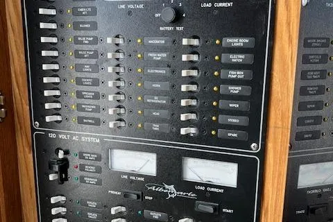 Slide: The Image of Electrical panel of a 1999 Albemarle 305 Express Fisherman boat, showing switches and gauges. - 16