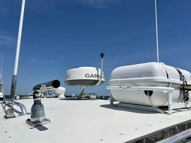 Slide: The Image of 1999 Albemarle 305 Express Fisherman boat deck with radar and life raft under clear sky. - 19