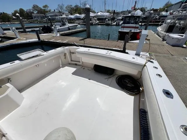 Slide: The Image of 1999 Albemarle 305 Express Fisherman boat docked at a marina, featuring spacious deck area. - 6