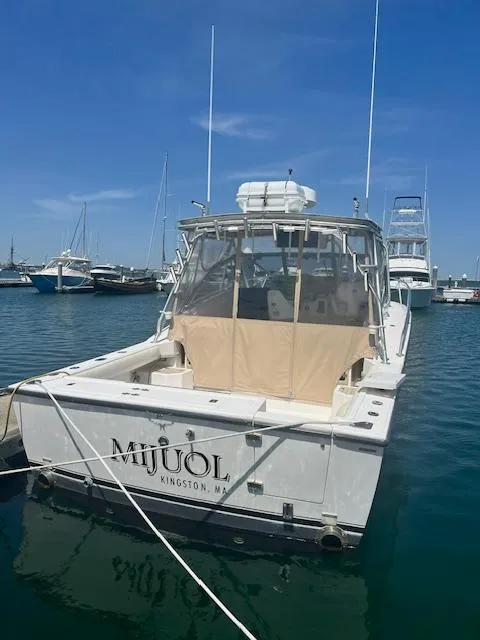 Slide: The Image of 1999 Albemarle 305 Express Fisherman boat docked in a marina under clear blue skies. - 8