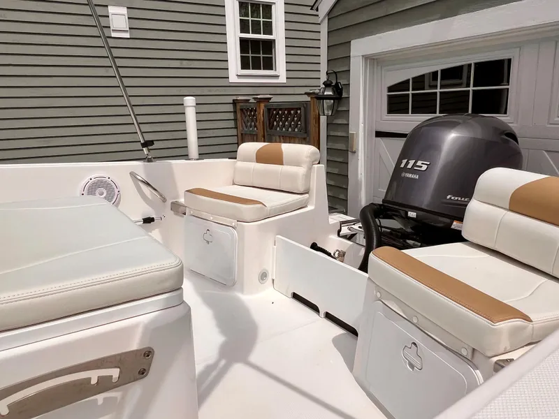 Slide: The Image of 2023 Edgewater 170CC boat interior with seating and Honda 115 engine. - 13