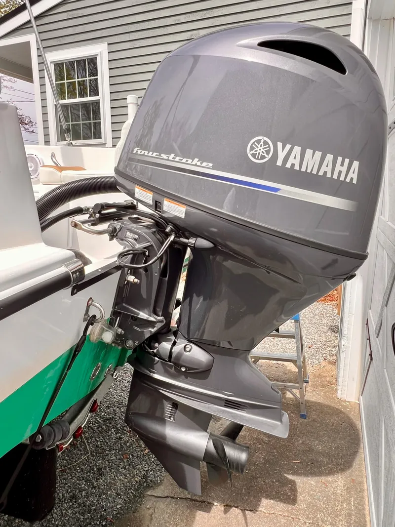 Slide: The Image of 2023 Edgewater 170CC boat with Yamaha outboard motor in a driveway setting. - 14