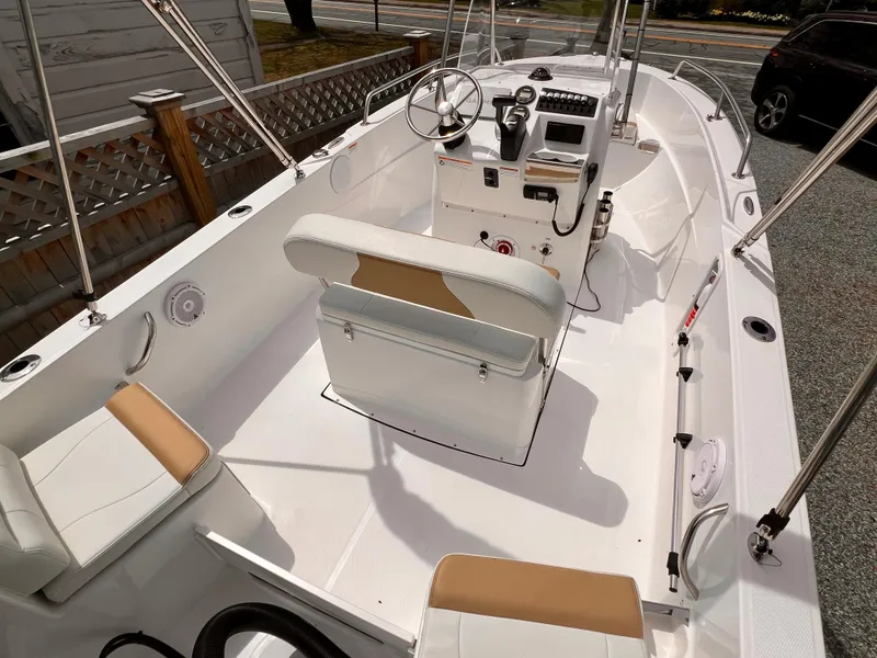 Slide: The Image of 2023 Edgewater 170CC boat interior with white seating and steering console. - 4