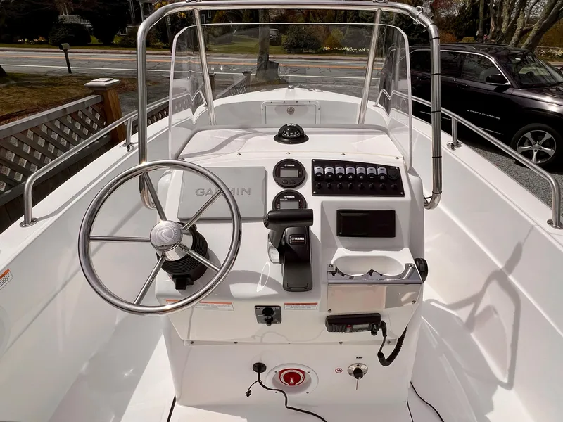Slide: The Image of 2023 Edgewater 170CC boat console with steering wheel and navigation controls. - 5