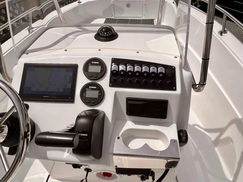 Slide: The Image of 2023 Edgewater 170CC boat dashboard with navigation controls and steering wheel. - 6