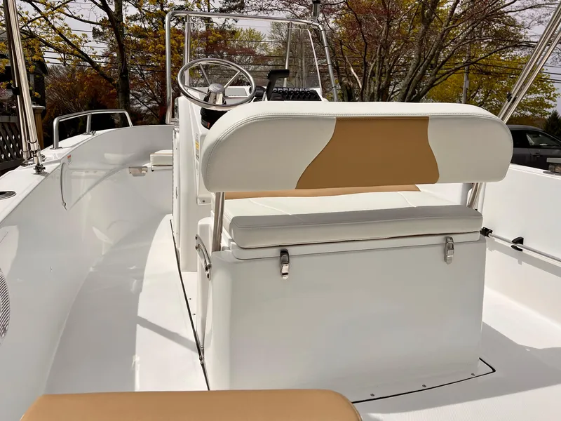 Slide: The Image of 2023 Edgewater 170CC boat interior with white seating and steering console. - 7