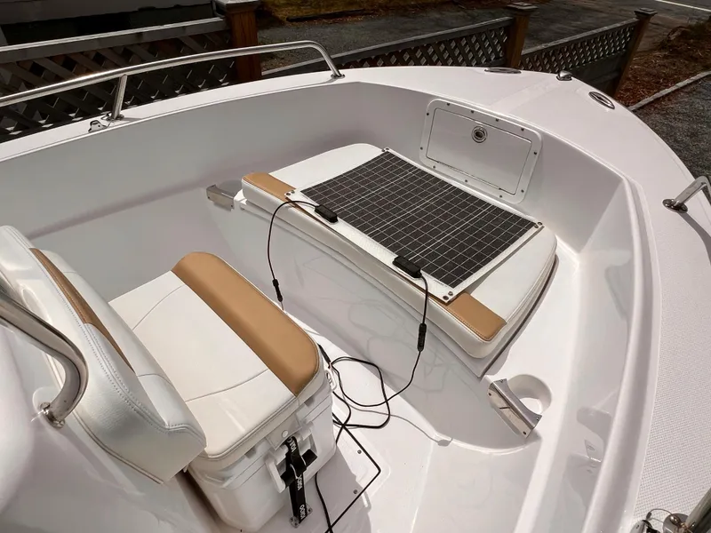 Slide: The Image of 2023 Edgewater 170CC boat interior with seating and solar panel setup. - 8
