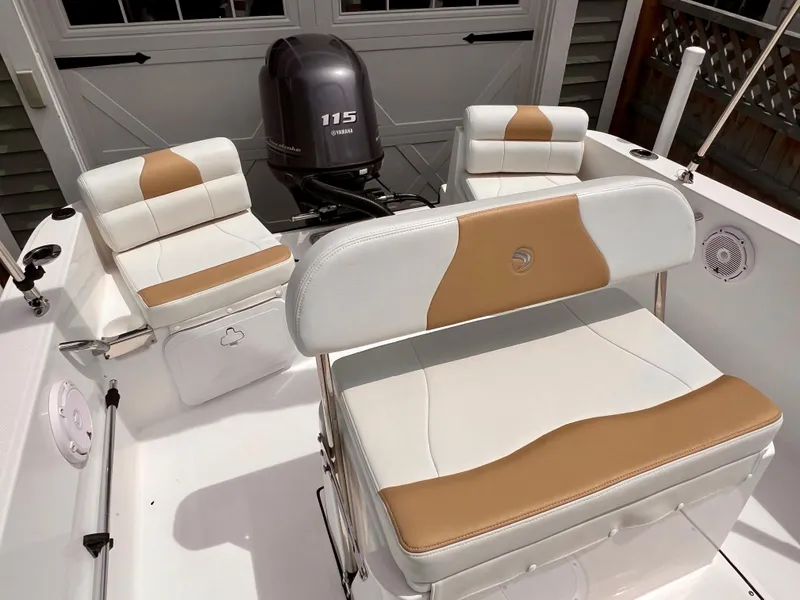 Slide: The Image of 2023 Edgewater 170CC boat interior with Yamaha 115 engine, featuring tan and white seating. - 9