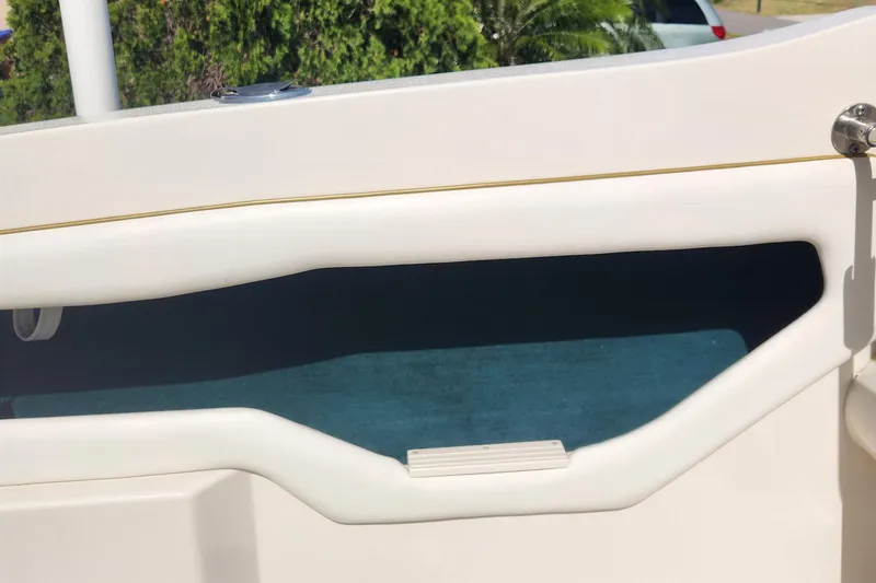 Slide: The Image of 2001 Sea Ray 215 boat interior detail with white and blue accents. - 11