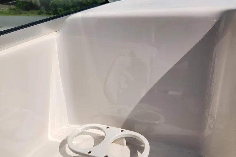 Slide: The Image of Interior detail of a 2001 Sea Ray 215 boat, featuring a cup holder. - 13