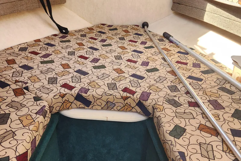 Slide: The Image of 2001 Sea Ray 215 cabin interior with patterned upholstery and metal poles. - 15