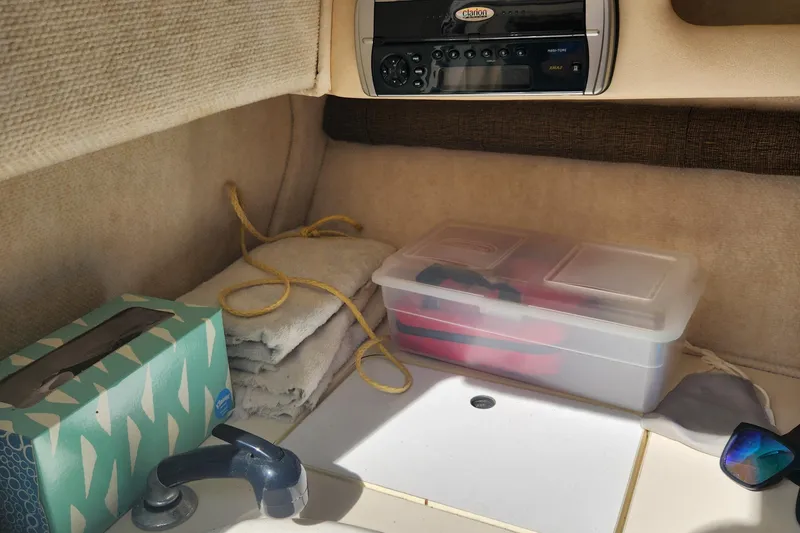 Slide: The Image of Interior of a 2001 Sea Ray 215 boat with storage and radio. - 17