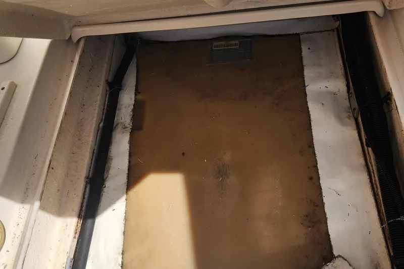 Slide: The Image of Storage compartment of a 2001 Sea Ray 215 boat, showing interior details. - 20