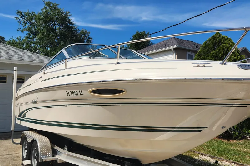 Slide: The Image of 2001 Sea Ray 215 boat on trailer, parked in driveway, sunny day. - 3