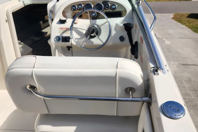 Slide: The Image of 2001 Sea Ray 215 boat interior with steering wheel and dashboard controls. - 6