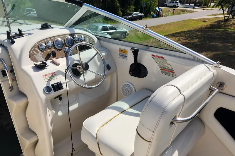 Slide: The Image of 2001 Sea Ray 215 boat cockpit with steering wheel and control panel. - 8