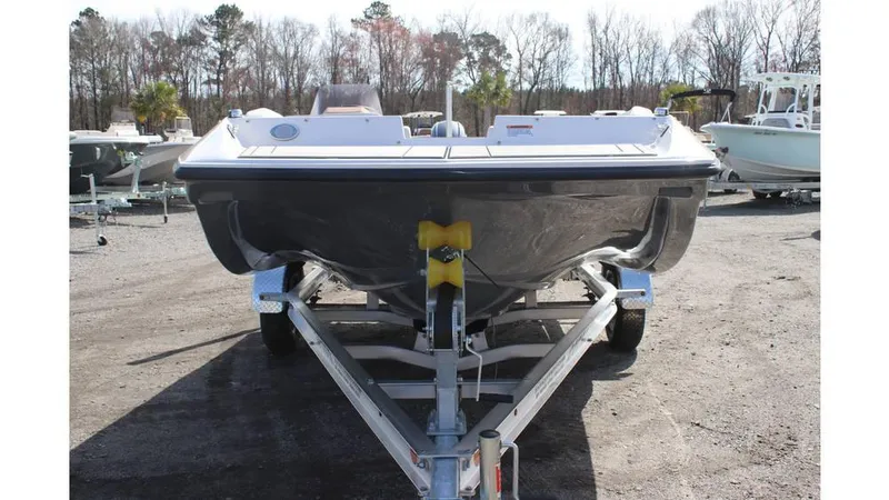 Slide: The Image of 2025 Starcraft SV 16 OB boat on trailer, parked outdoors, front view. - 1